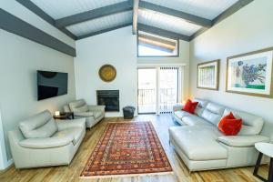 a living room with white couches and a fireplace at Marcs Red Rock Retreat 2 Primary Suites 2 Bath in Sedona
