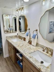 a bathroom with two sinks and two mirrors at Serenity Now in Beautiful Sedona - 3 BR 2 BA in Sedona