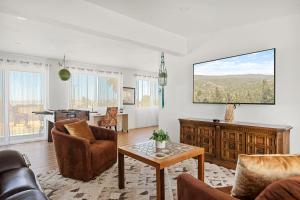 a living room with a couch and a table at Bighorn Oasis with a Hot Tub in Twentynine Palms