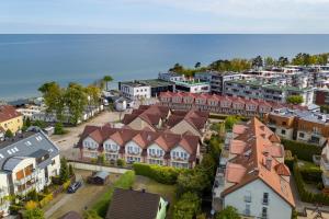 an aerial view of a town with houses and the ocean at Skorpion in Rewal