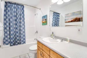 a bathroom with a sink and a toilet at Sail Boat Manor in Garden City +35 photos