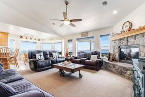 a living room with leather furniture and a fireplace at Sail Boat Manor in Garden City