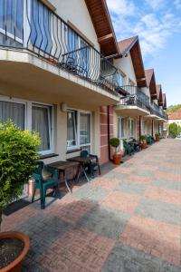 a building with a patio with tables and chairs at Skorpion in Rewal