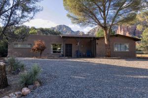 a house with a gravel driveway in front of it at Peaceful Desert Hideaway in Sedona