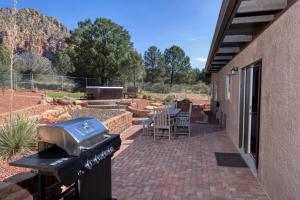a patio with a grill and a table and chairs at Peaceful Desert Hideaway in Sedona