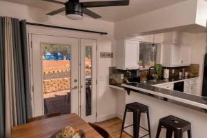 a kitchen with a table and a ceiling fan at Peaceful Desert Hideaway in Sedona