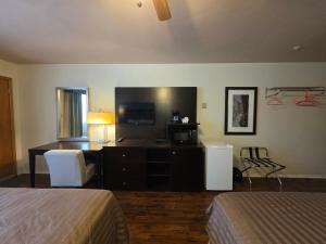 a hotel room with two beds and a desk at Shenstone Motor Inn in Wiarton +43 photos