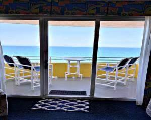 a view of the ocean from a room with a table and chairs at Wyndham Ocean Walk Resort Daytona Beach 1605 - 16th Floor 1 BR Resort Condo Direct Oceanfront in Daytona Beach