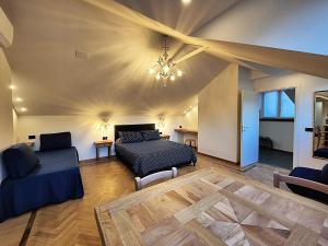 a living room with a bed and a couch and chairs at Residenza Laurum in Mandello del Lario