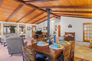 a living room with a wooden table and chairs at Mountain Retreat Woodburning Fireplace Games in Big Bear City
