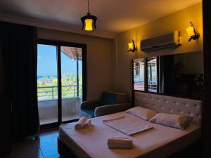 A bed or beds in a room at Adrasan Yazıcı Hotel