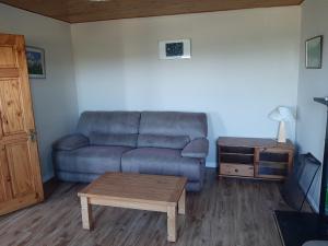 a living room with a couch and a coffee table at Teach Chnoc na hEorna in Goleen