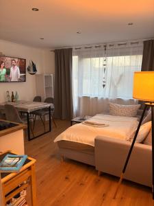 a bedroom with a bed and a dining room at Ferienhaus bei Engel in Ahrensbök