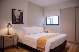 a bedroom with a large bed and a window at Aguirre By Wynwood House in Lima