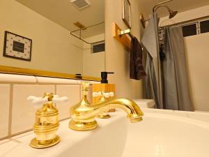 a bathroom with a sink with a gold faucet at 3BR Home w Game Room by The Village, Lake & Summit in Big Bear Lake +44 photos