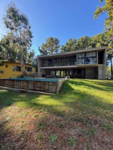 a large house with a swimming pool in the yard at Casa de lujo en Costa Esmeralda in Costa Esmeralda