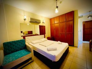 A bed or beds in a room at Adrasan Yazıcı Hotel