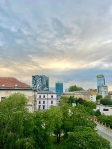 a view of a city with tall buildings and trees at Apartments VRAZOVA in Sarajevo