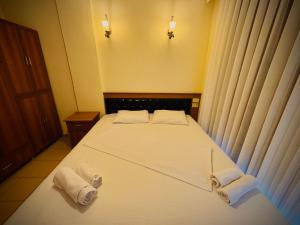 A bed or beds in a room at Adrasan Yazıcı Hotel