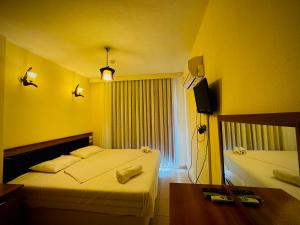 A bed or beds in a room at Adrasan Yazıcı Hotel