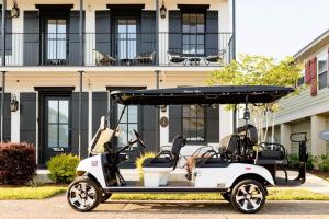 a golf cart parked in front of a building at Suite C Beach, Firepit, Dog-friendly, Downtown! in Biloxi