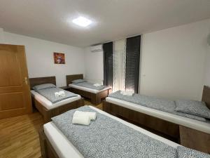 a room with three beds and a window at Villa Panorama in Bihać +39 photos