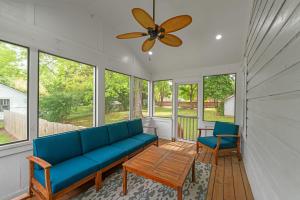 a living room with a blue couch and two chairs at Bungalow off Floyd St in the heart of Covington bungalow in Covington