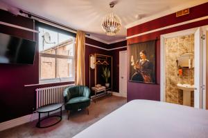 a bedroom with a bed and a chair and a window at Unique Shrewsbury Rooms in Shrewsbury