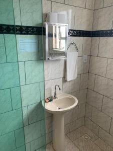 a bathroom with a sink and a mirror at Casa pôr do sol in São Pedro da Aldeia