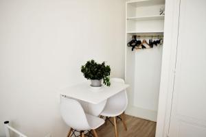a small white table and two white chairs in a room at Private place in the city center, private bathroom in Nice