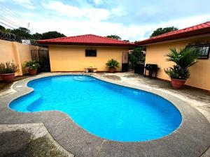 a swimming pool in front of a house at Casa Serena! in Coco