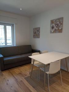 a living room with a couch and a table at Edera Hall Inclusive in Cerano d'Intelvi +1 photo