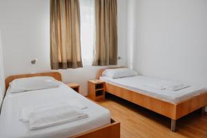 a room with two beds and a window at Sobe Kozina in Međugorje