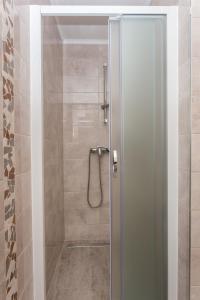 a shower with a glass door in a bathroom at Guest House Eight Roses in Dubrovnik