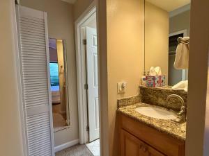a bathroom with a sink and a mirror at A9 Direct Oceanfront 2 Level 2 Lanai Amazing Views Sunsets & AC Comfort in Lahaina