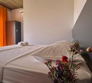 a bedroom with a large white bed with flowers on it at Ballkan in Shkodër