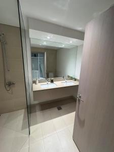 a bathroom with two sinks and a mirror at Gorgeous 2br Etihad Arena Yas in Abu Dhabi