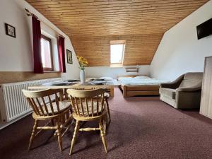 a living room with a table and chairs and a bed at U Javoru in Albrechtice v Jizerských horách