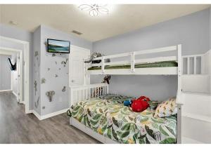 a bedroom with two bunk beds in a room at 3157 YL - Encantada Serenity Retreat Elegant Villa Close to Disney in Kissimmee
