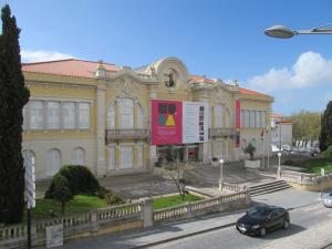 a building with a car parked in front of it at Casa Azul Hostel in Sintra