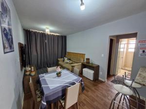 a living room with a table and a couch at Apto no Centro de São Leopoldo in São Leopoldo