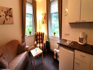 a living room with a couch and a table at Ferienwohnung in Wildemann in Wildemann