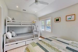 a bedroom with two bunk beds and a window at Thayer Beach Lakehouse in Colchester