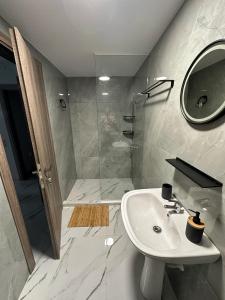 a white bathroom with a sink and a shower at Fintirik Cozy Stay in Stavros +8 photos