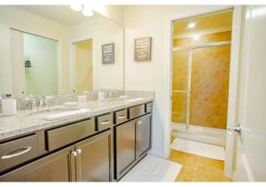 a bathroom with two sinks and a shower at Fabulous 5BR Villa Marvel Private Pool - Solterra Retreat in Davenport
