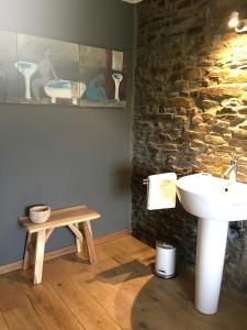 a bathroom with a sink and a table at Atelier n°5 in Wanze