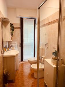 a bathroom with two toilets and a sink at ALPI & RELAX Sondrio - zona Ospedale - centro città in Sondrio +14 photos