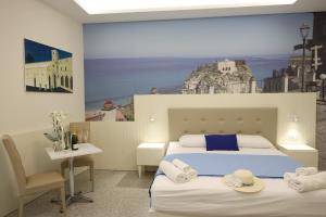 a bedroom with a bed with towels on it at Nazzarì B&B Tropea in Tropea