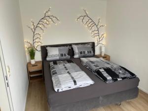 a bed with two pillows on it in a room at Ferienwohnung Am Wasen in Pleinfeld