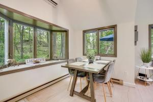 a dining room with a table and chairs and windows at South Salem Vacation Rental with Furnished Deck! in South Salem +21 photos